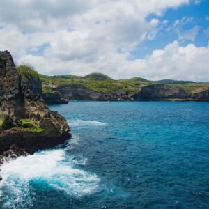 Stunning coastal cliffs and vibrant blue ocean at Nusa Penida, Bali, Indonesia.