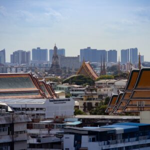 Skyline view of Bangkok highlighting traditional Thai architecture amidst modern buildings.